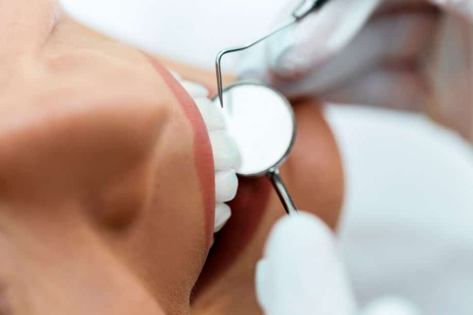 dental implements near patient's teeth