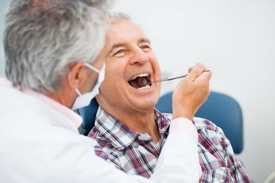 dentist cares for mature patient