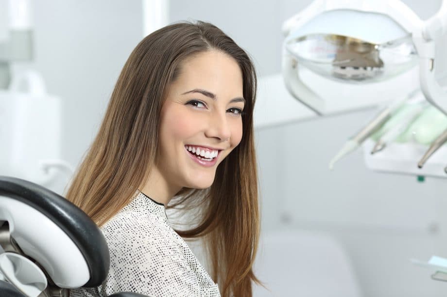 woman smiling in a dentist chair